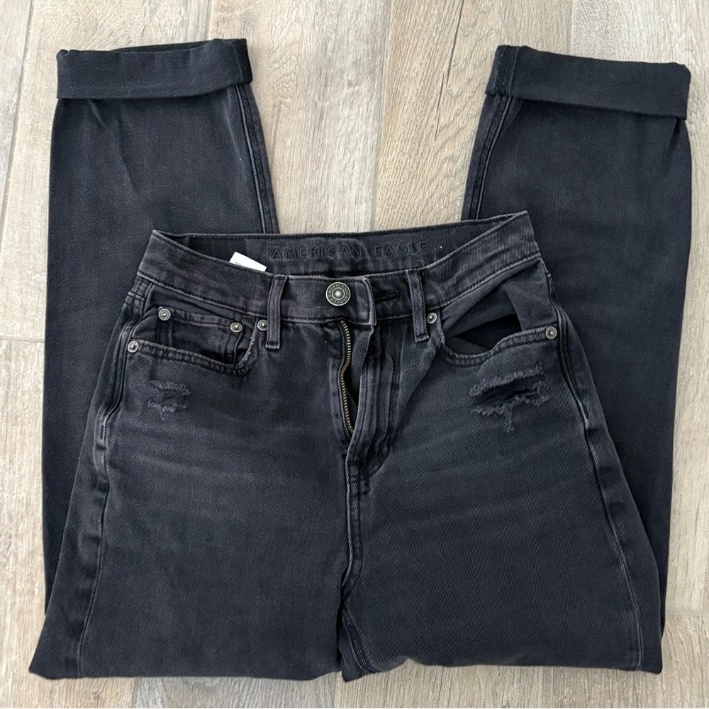 Black high-waisted straight-leg denim jeans with a distressed finish